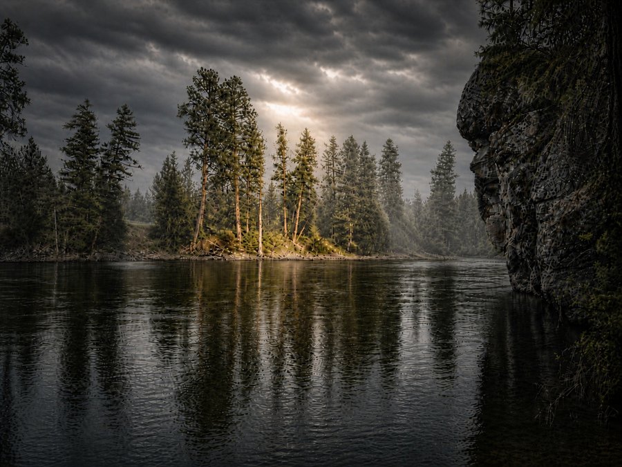 Dark lake beneath storm clouds with a small pine-covered island illuminated by a shaft of sunlight.